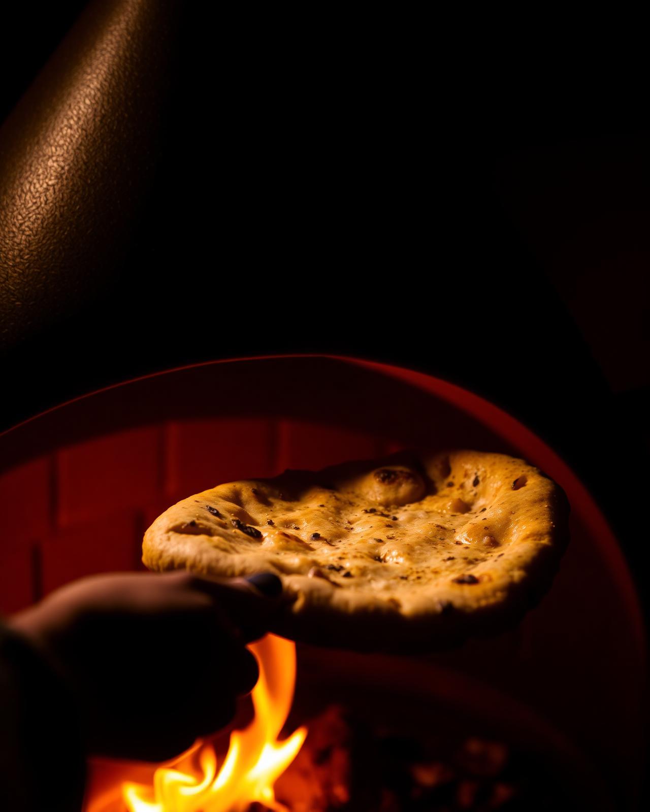 Fresh naan pulled from clay tandoor